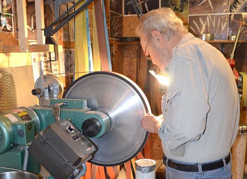 shop mechanic using the burr king bba20 20" grinding wheel in basement