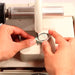 close up of person's hands cutting a stone on the cab king 8 trim saw attachment for sale