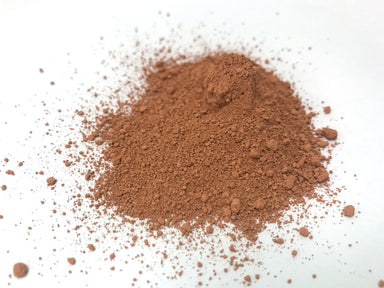 pile of reddish-brown cerium oxide polish on white background