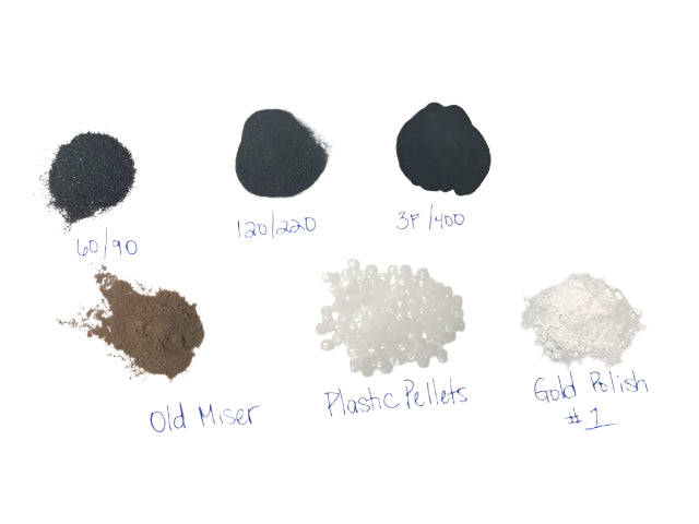 collection of 7 small piles of materials for a rock tumbler on a white background including grit, polish and plastic pellets