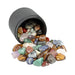 mixed colorful batch of rocks in a pile coming out of a black barrel with a white background